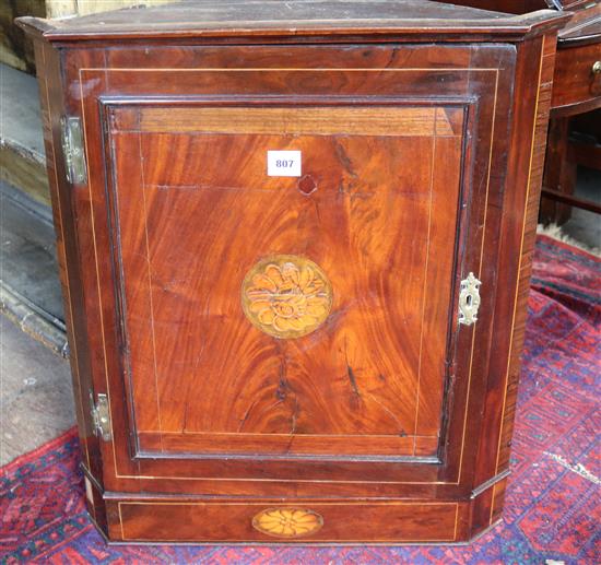 A George III strung mahogany hanging corner cupboard, W. 2ft 2in. D. 1ft 4in. H. 2ft 8in.(-)